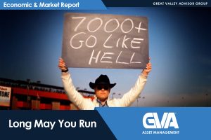 Person in a cowboy hat holding a protest sign that reads '7000+ GO LIKE HELL' against a stadium backdrop, with corporate banner overlays.